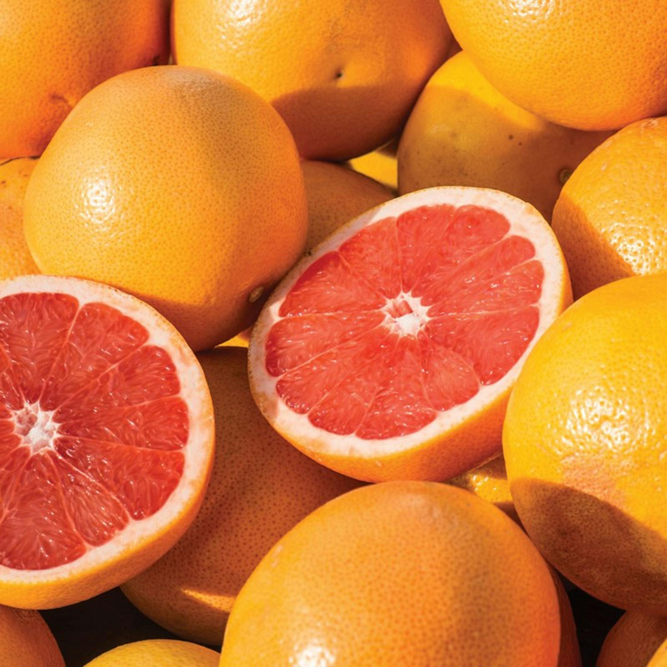 A pile of citrus and one cut open